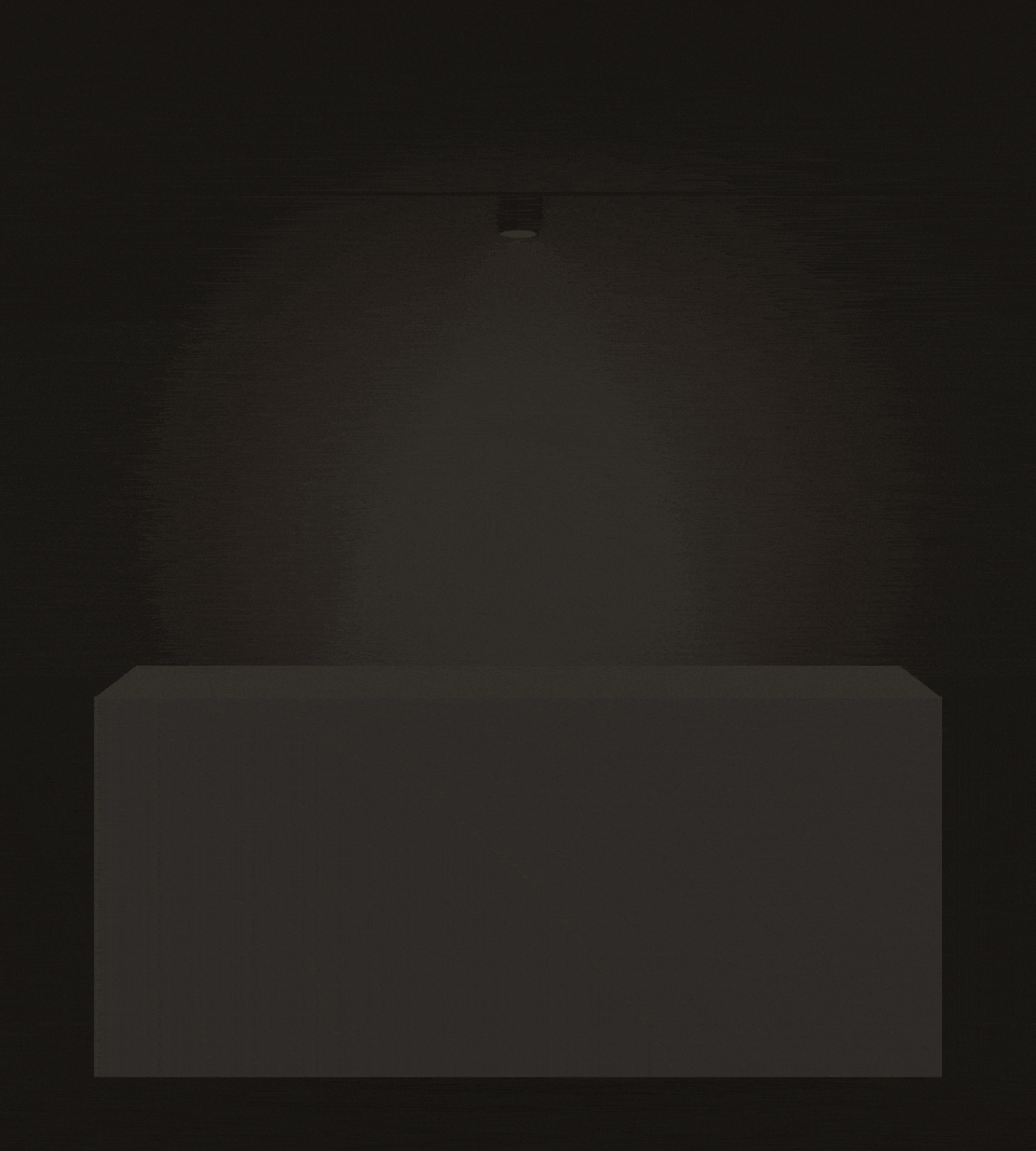 An empty, unlit plinth in a dark gallery. A spotlight switches on above it, and the label types out: Your idea. Not yet abandoned. Opening soon. The picture holds on the lit, empty plinth.